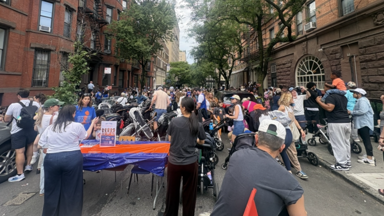 Children, parents, and caregivers gather outside the Children’s Museum of Manhattan to celebrate the Knicks win with music, crafts, and other activities.