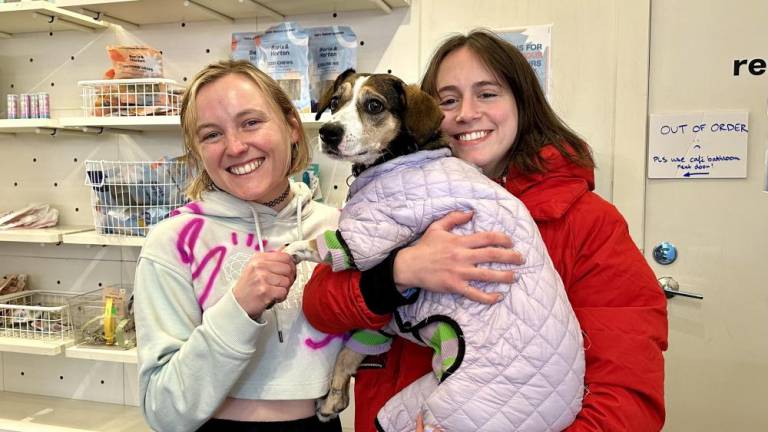 <b>The dog side staff, Astor Gross (left) and Annabeth Mann (right) with a loyal customer, Biscuit. The owners of Boris &amp; Horton are now hopeful that the closure that they feared would happen Feb. 26 can be forestalled as patrons try to rally support. </b>
