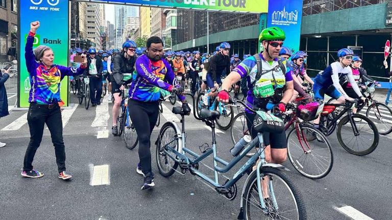Legally blind biker Terrel Dobbins (in purple vest on back of tandem bike) was the stoker with pilot Marc Goldstein. Dobbins lost his sight in 2016 and said he had not ridden in 30 years before he began training for the 40-mile tour in March.