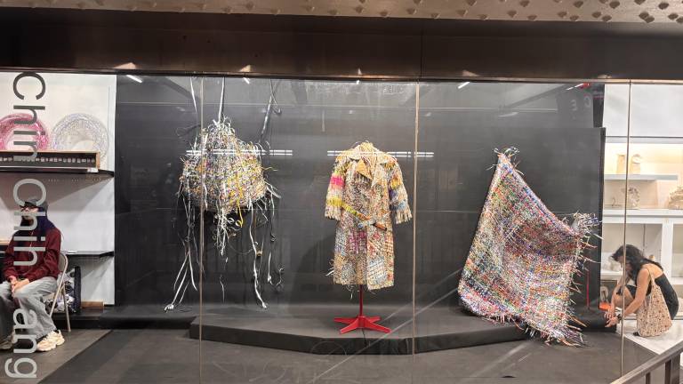 Works by Chin-Chih Yang are displayed behind the glass storefront of Whitebox Portable, a gallery located inside the Times Square subway complex.