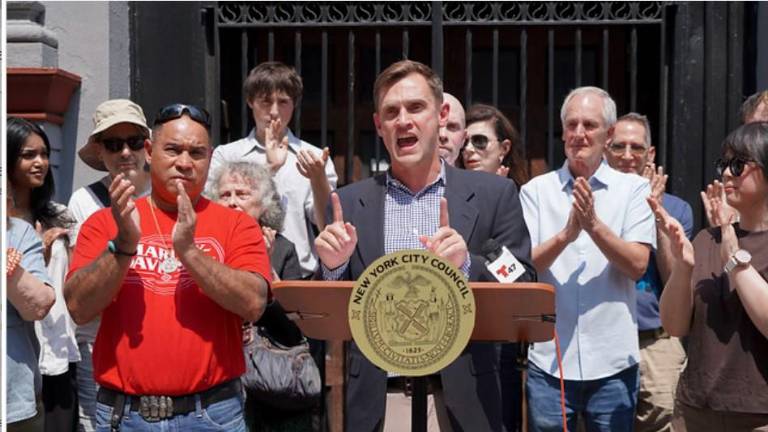 Carl Wilson led preservationists in a “Stop the Sale” rally outside Our Lady of Guadalupe Church in Chelsea after learning the Archdiocese plans to sell the church and two former Catholic school buildings on the west side. He wants the Landmarks Preservation Commission to declare the buildings landmarks.